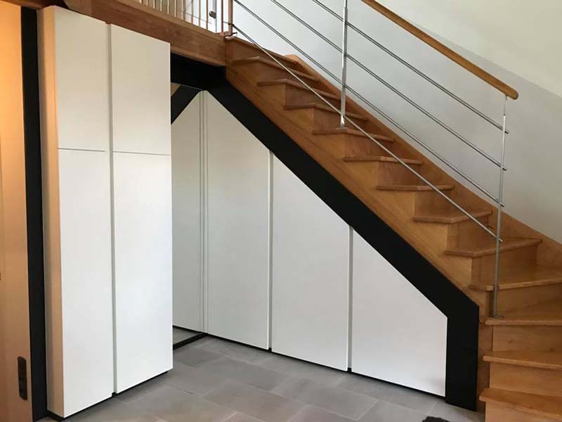 Aménagement de placards sous escalier, de couleur noir et blanc